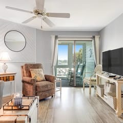 Second-floor villa w/ river views & community pool, tennis courts, and dock