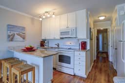 Beachfront condo with pool, beach access, pier, private balcony, & central AC