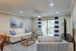 Fully updated condo with serene view, enclosed balcony, WiFi, W/D, pool, & gym