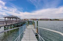 Inviting waterfront townhouse with beach access, balcony, W/D, pool & dock