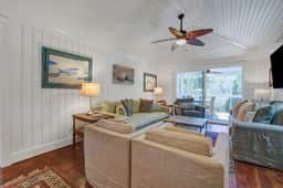 Palm-surrounded abode with screened-in balcony, chef's kitchen, smart TVs, & W/D