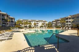 Second-floor villa with lovely ocean views, pickleball, pool & screened deck