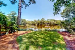 Updated island estate with serene lagoon views & 2 decks - bike to beach