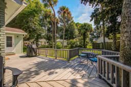 Refined coastal home surrounded by palms with large deck & athletic court access - Image 3