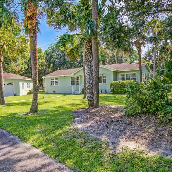 Refined coastal home surrounded by palms with large deck & athletic court access - Image 1
