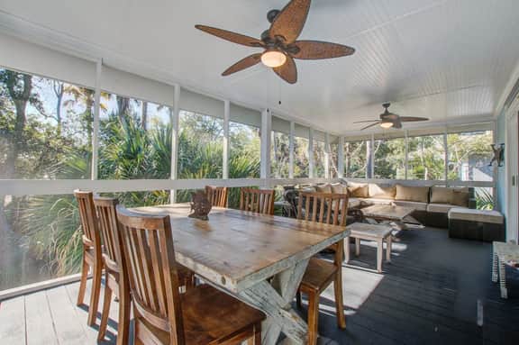 Palm-surrounded abode with screened-in balcony, chef's kitchen, smart TVs, & W/D