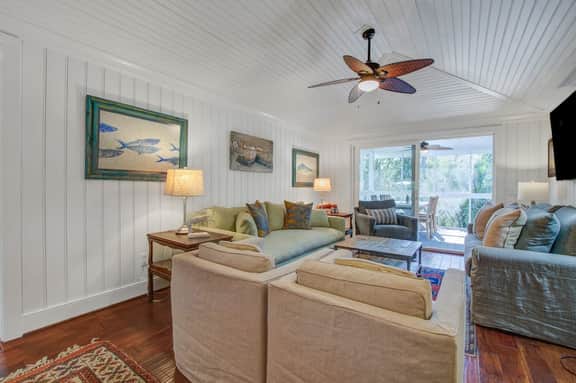 Palm-surrounded abode with screened-in balcony, chef's kitchen, smart TVs, & W/D
