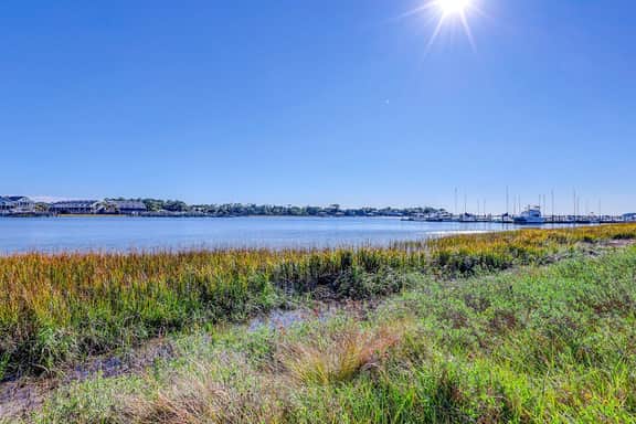 Riverfront condo with pool, 2 tennis courts, & screened porch - near beach