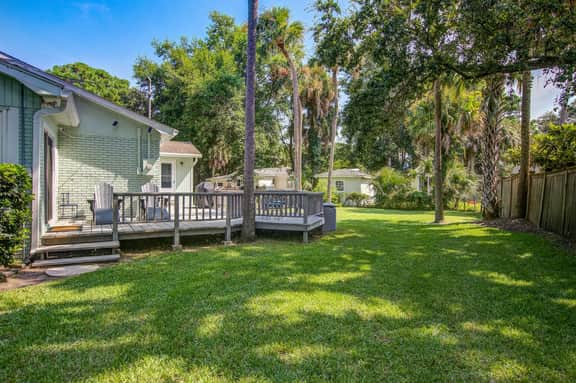 Refined coastal home surrounded by palms with large deck & athletic court access - Image 4