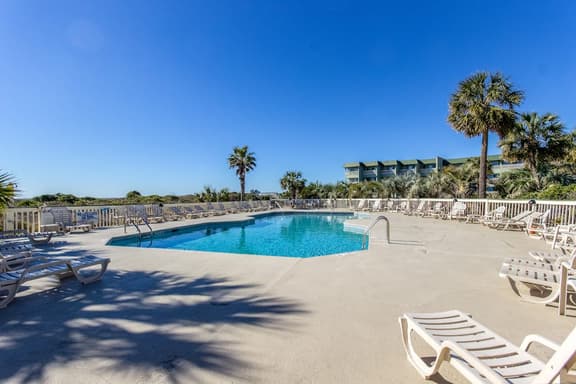 Oceanfront condo with water views, pool, balcony, & easy beach access